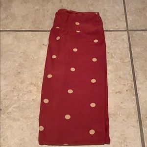 Pair of red and gold polka dot leggings